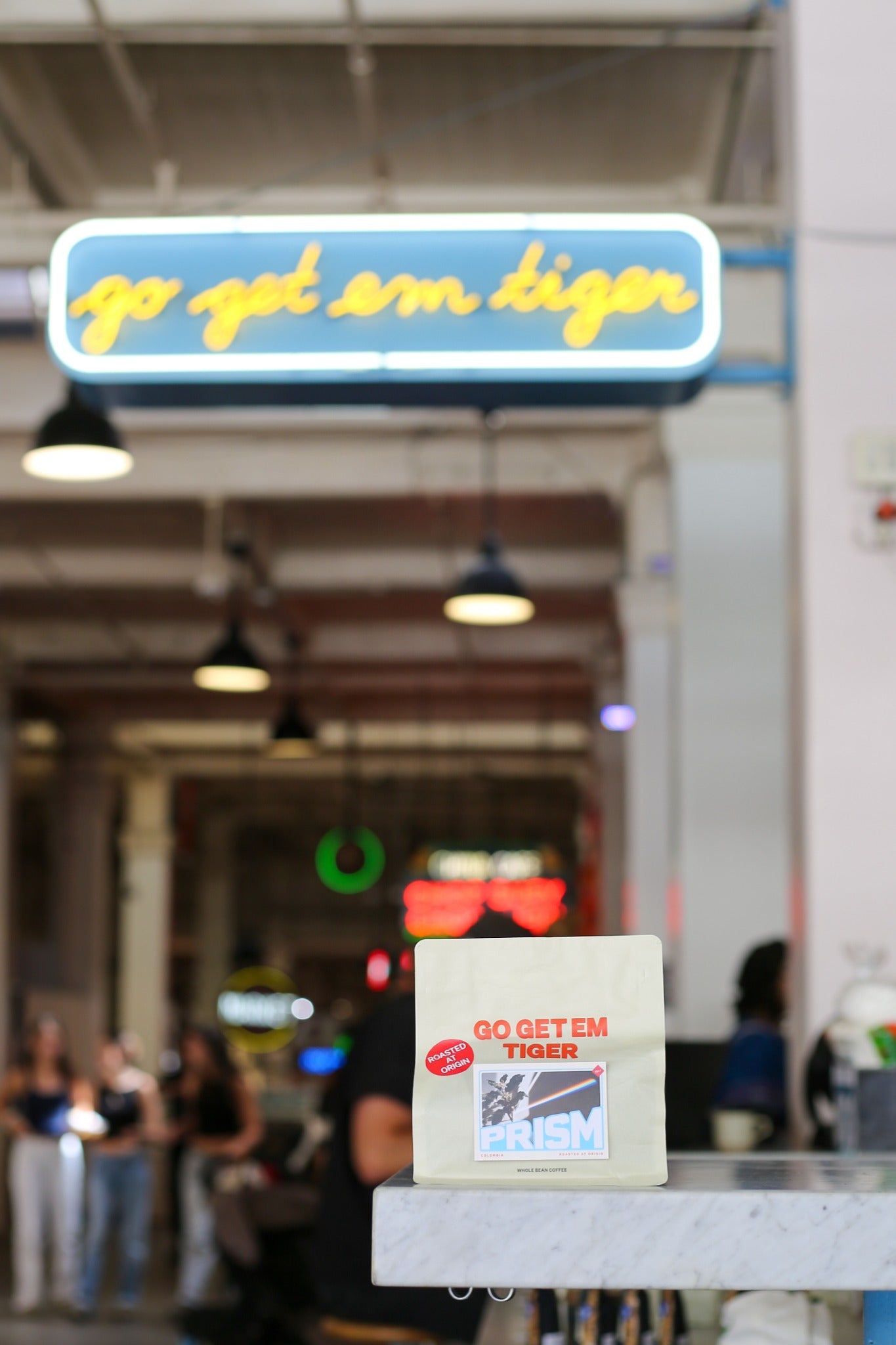 Prism coffee beneath the Go Get Em Tiger sign